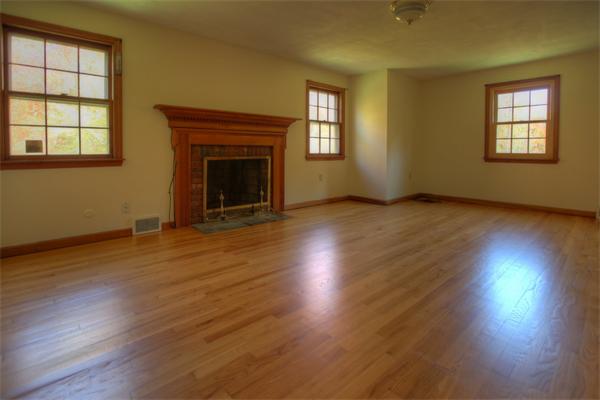 103 Hartland Road Tolland, MA 01034 - Photo 8 of 12 a view of an empty room with wooden floor and a window