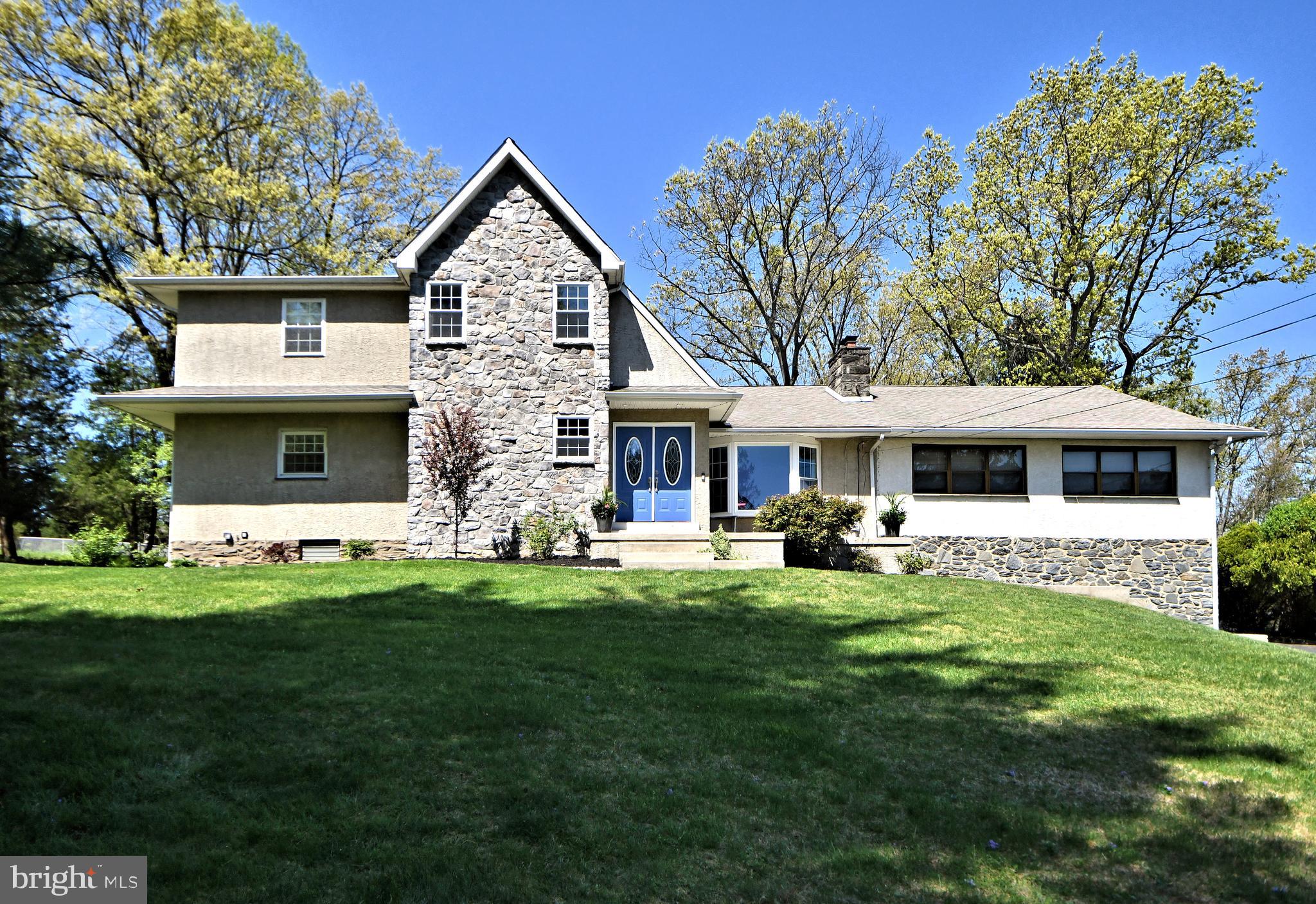 a front view of house with yard and green space