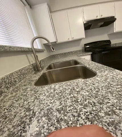 a kitchen with a sink and cabinets