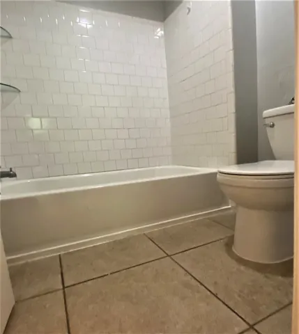 a bathroom with a toilet and a bathtub