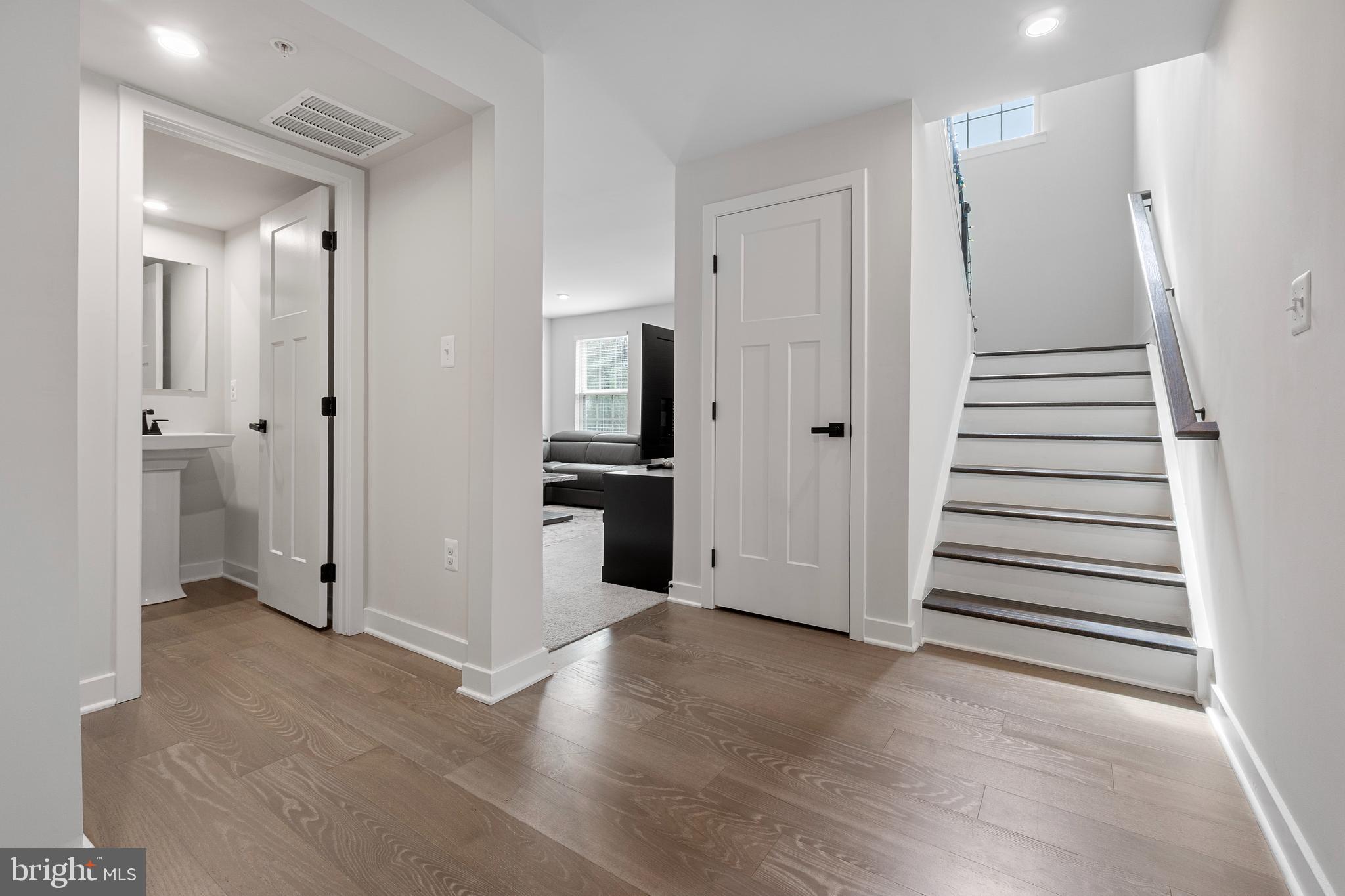 7922 Brandy Station Road Hanover, MD 21076 - Photo 11 of 22 a view of a hallway with wooden floor and staircase