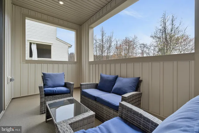 a outdoor living room with furniture and a window