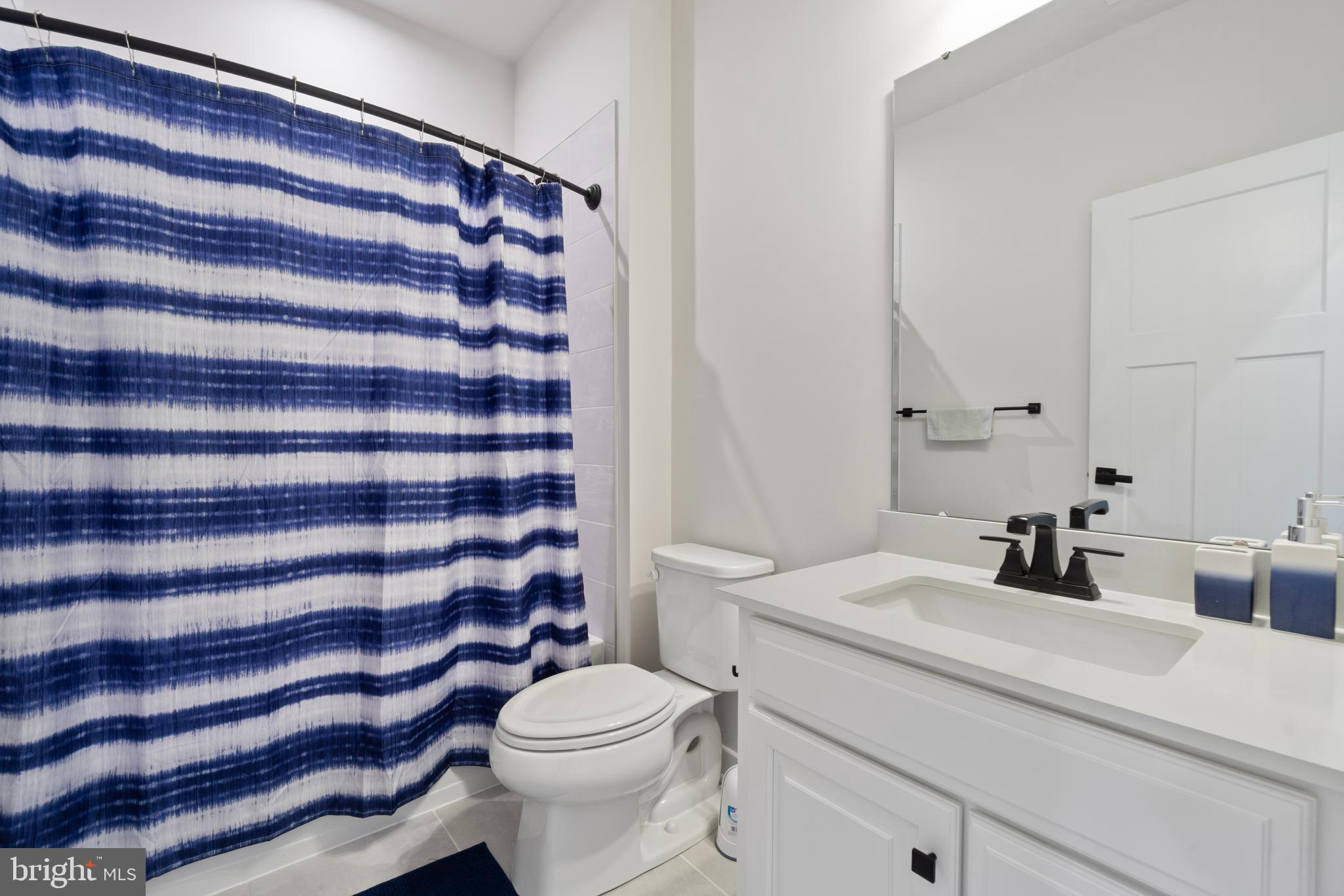7922 Brandy Station Road Hanover, MD 21076 - Photo 14 of 22 a bathroom with a sink a toilet and a mirror