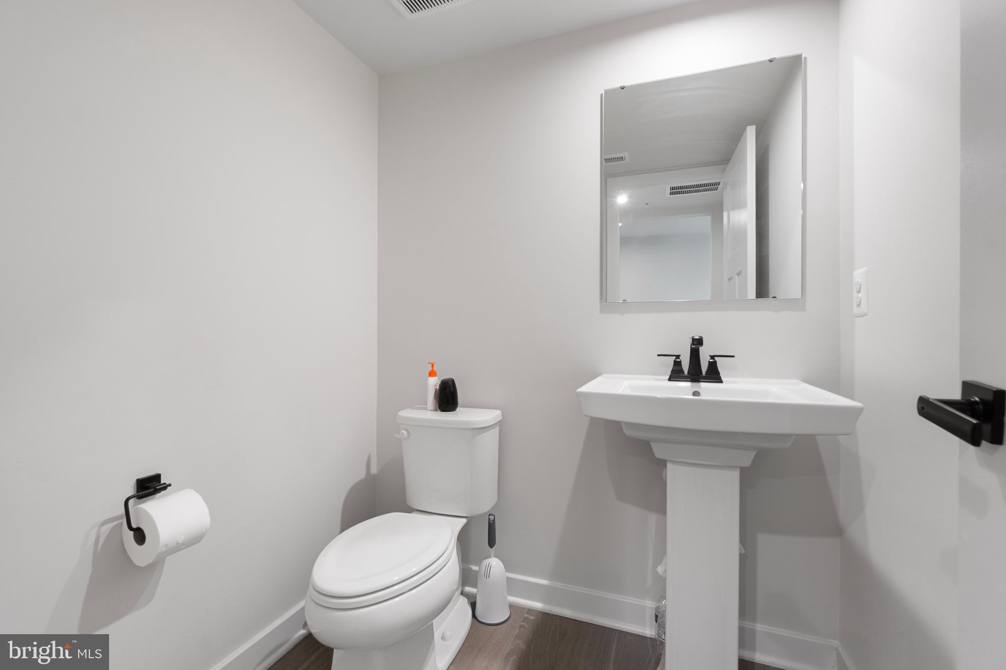 7922 Brandy Station Road Hanover, MD 21076 - Photo 16 of 22 a bathroom with a toilet sink and mirror