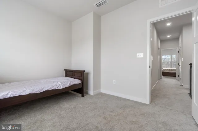 a bedroom with a bed and view of bathroom