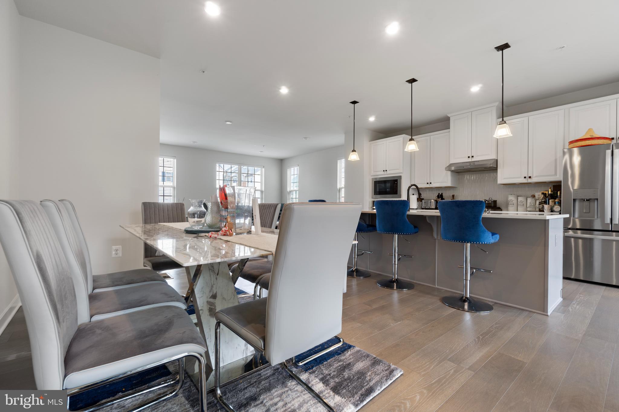 7922 Brandy Station Road Hanover, MD 21076 - Photo 2 of 22 a view of kitchen with stainless steel appliances kitchen island granite countertop dining table chairs and a rug