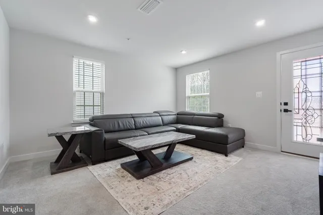a living room with furniture and windows