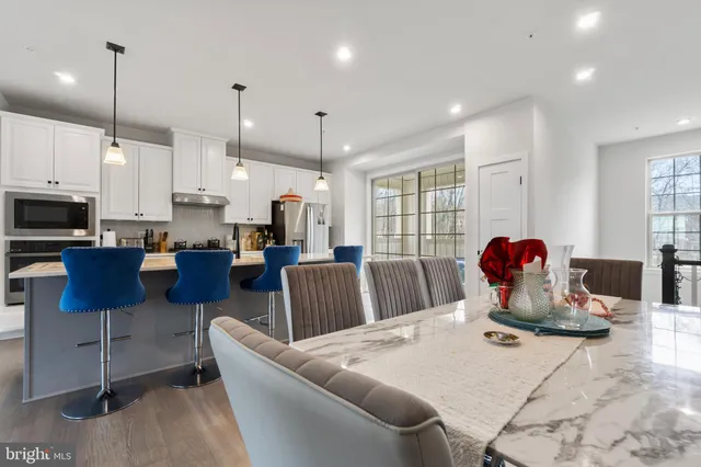 a living room with lots of furniture and kitchen view