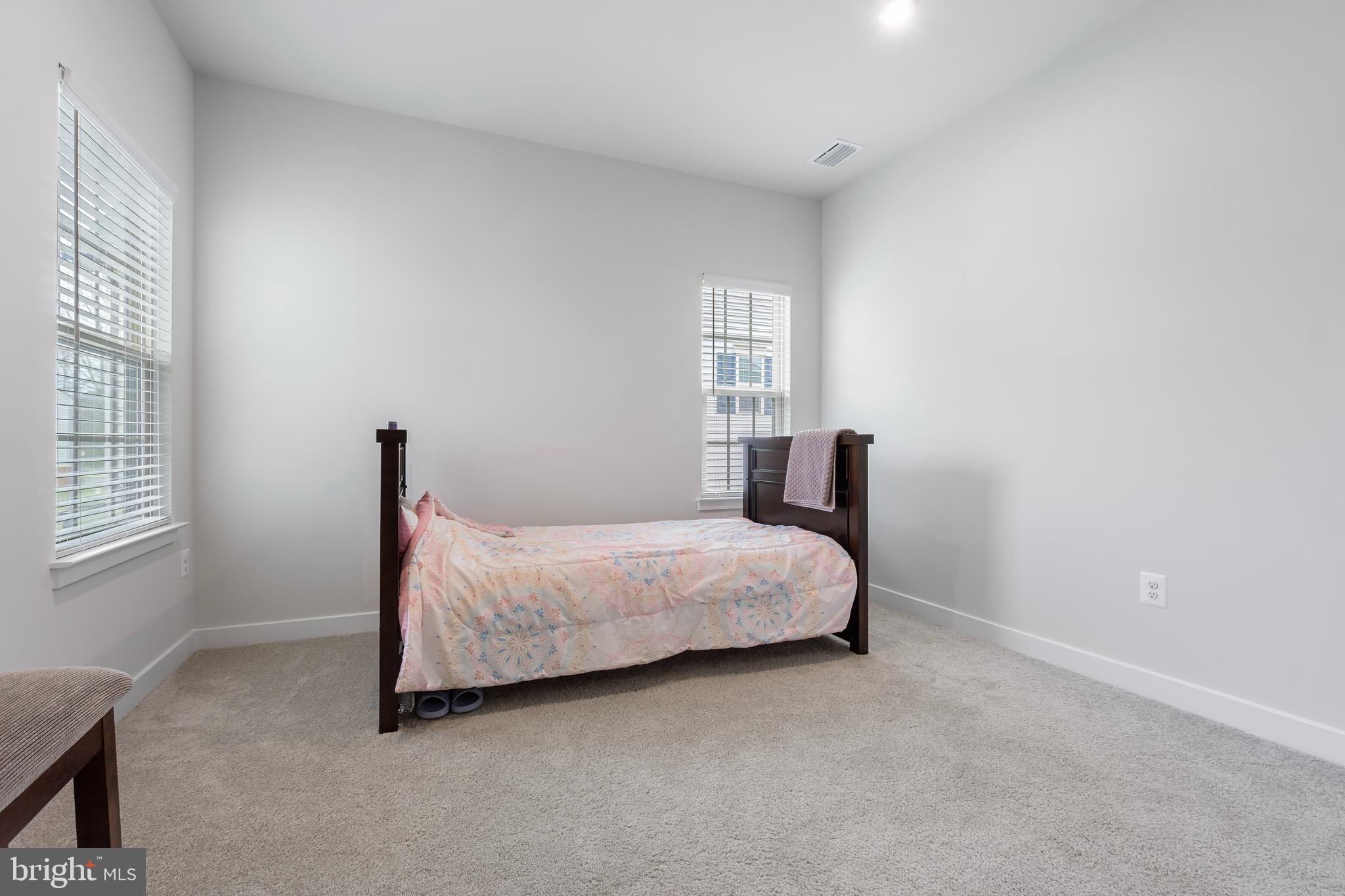7922 Brandy Station Road Hanover, MD 21076 - Photo 8 of 22 a bedroom with a bed and window