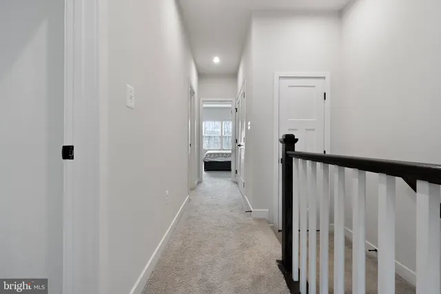 a view of a hallway with wooden floor and entryway