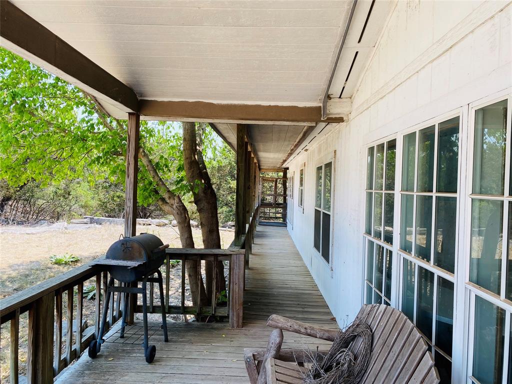 a view of a porch with furniture and backyard