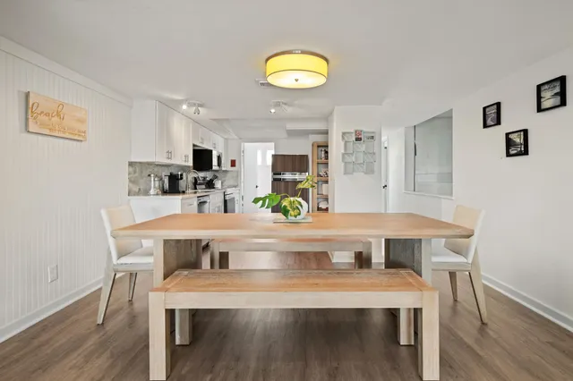 a bedroom with a bed a chair and potted plant