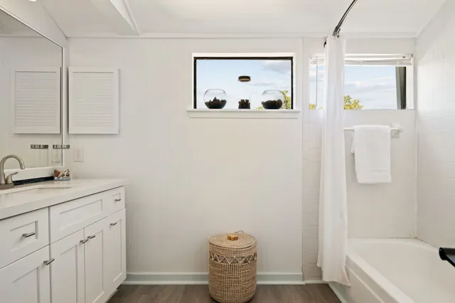 a bathroom with a granite countertop sink and a mirror