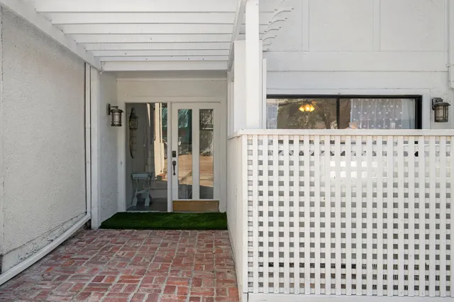 a view of a swimming pool with a patio and a garden