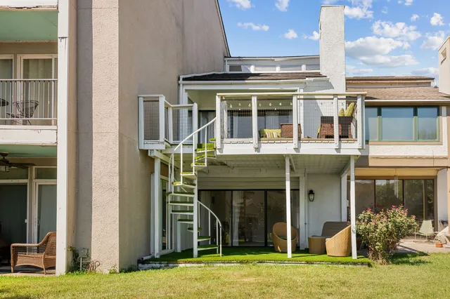 a view of a room with wooden floor and white walls