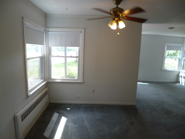 809 St Andrews Drive Crete, IL 60417 - Photo 15 of 24 a view of an empty room with window and chandelier fan