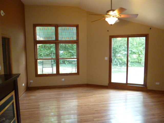 809 St Andrews Drive Crete, IL 60417 - Photo 2 of 24 a view of an empty room with a window and wooden floor