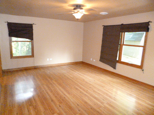 809 St Andrews Drive Crete, IL 60417 - Photo 9 of 24 a view of an empty room with wooden floor and a window