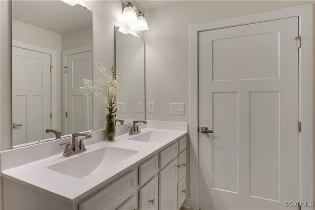 a bathroom with a sink vanity and a mirror