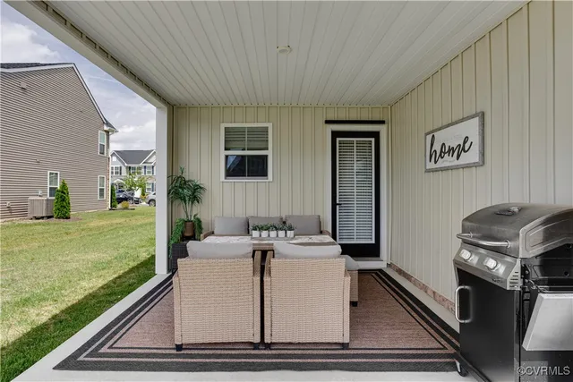 a view of a house with a barbeque grill and a garden