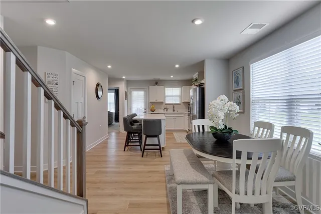 a dining room with furniture and wooden floor