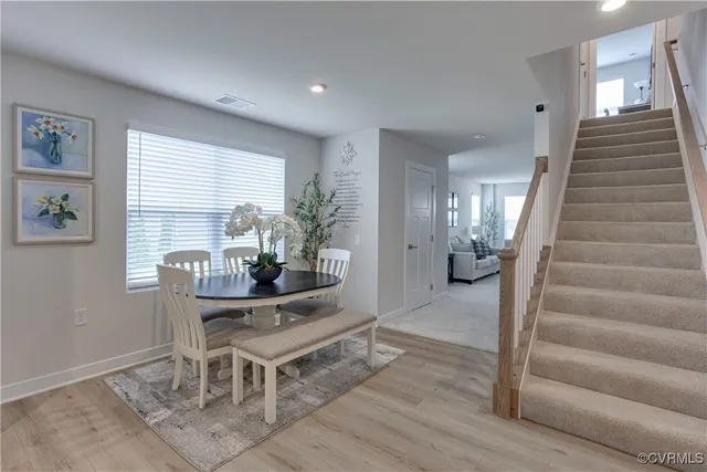 a dining room with furniture and wooden floor