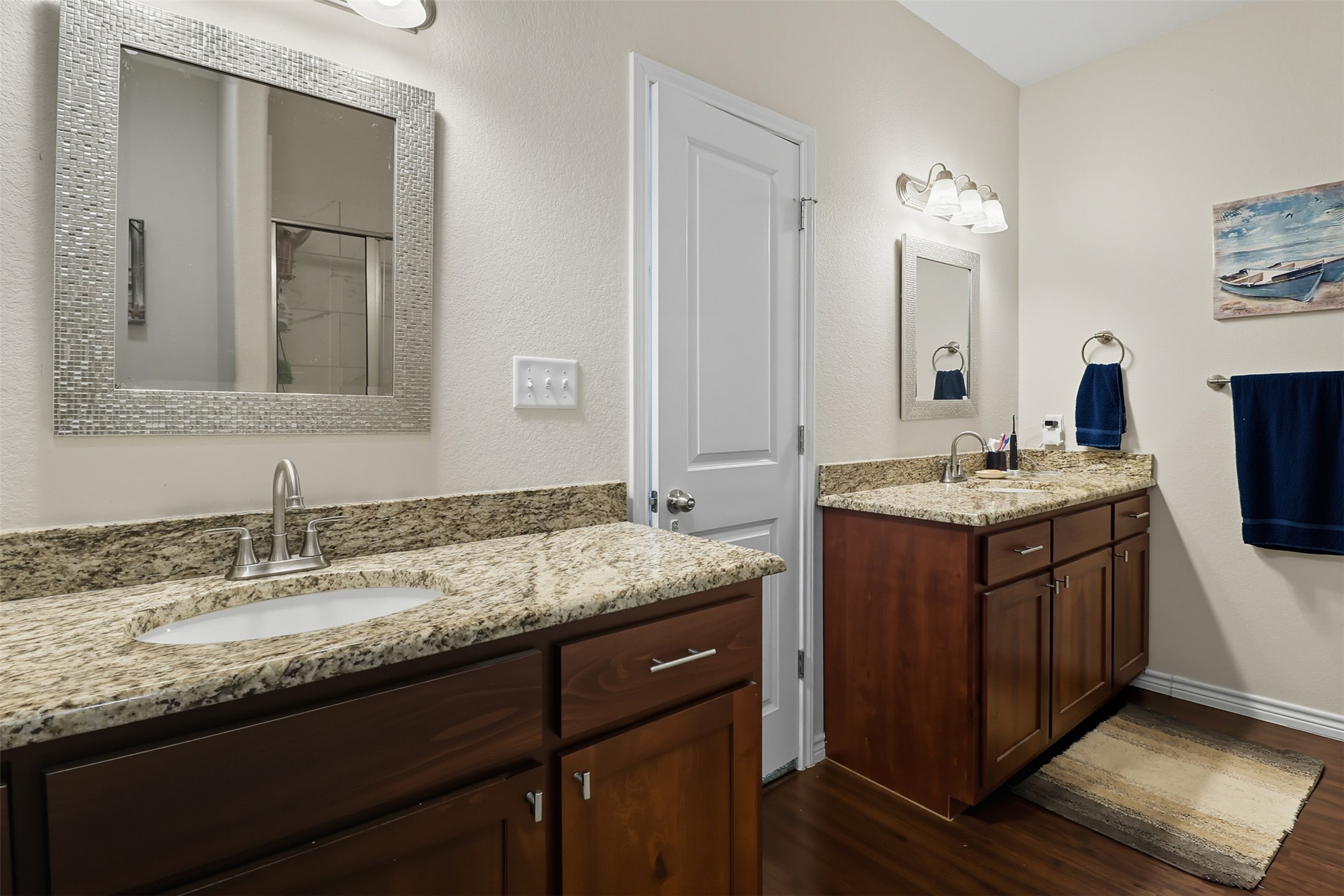 113 Rio Vista Road Burnet, TX 78611 - Photo 13 of 28 Full bathroom with dark wood-style floors, two vanities, and tiled shower