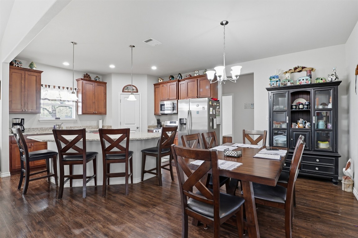113 Rio Vista Road Burnet, TX 78611 - Photo 9 of 28 Dining area featuring dark wood-type flooring, a chandelier, and recessed lighting