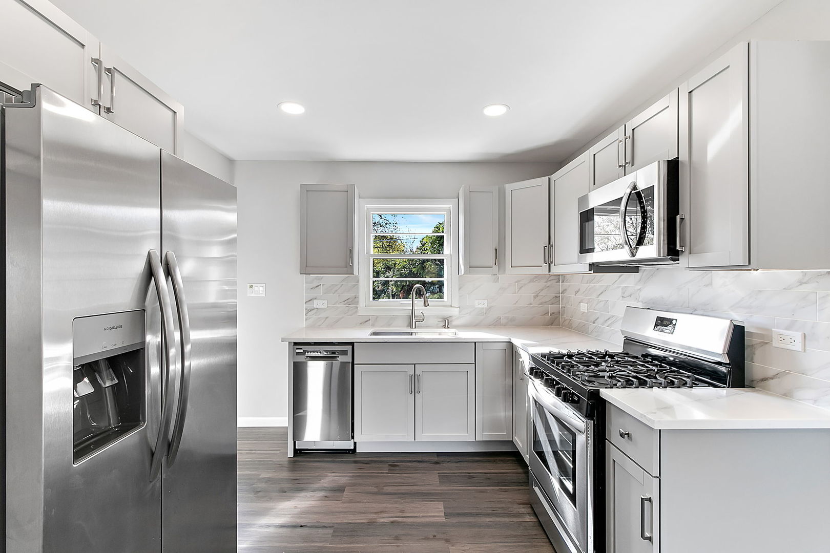 23519 West Renwick Road Plainfield, IL 60586 - Photo 15 of 22 a kitchen with stainless steel appliances a sink stove and refrigerator