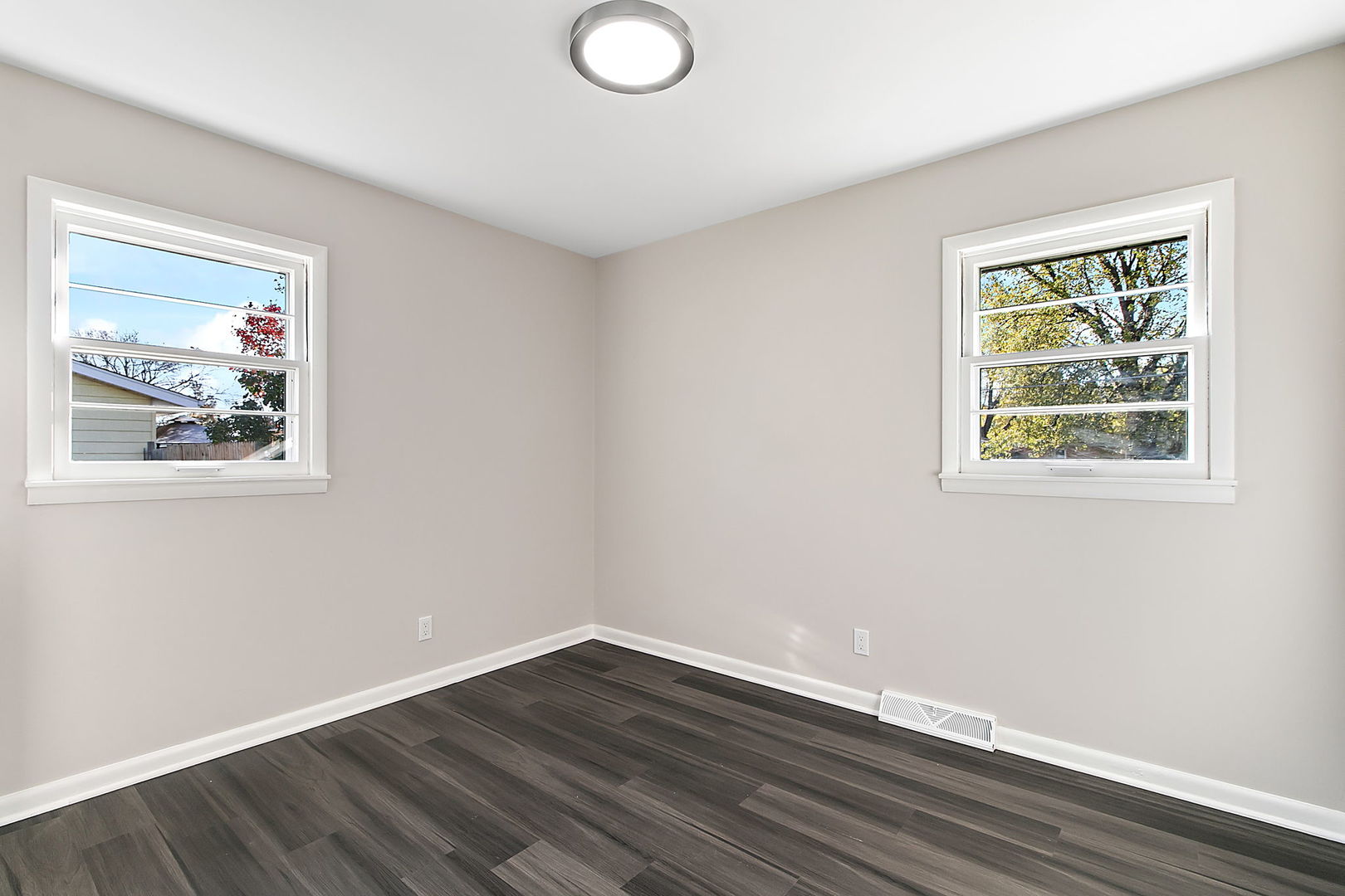 23519 West Renwick Road Plainfield, IL 60586 - Photo 7 of 22 a view of an empty room with wooden floor and a window