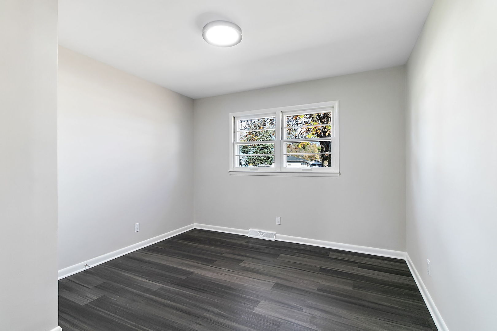 23519 West Renwick Road Plainfield, IL 60586 - Photo 8 of 22 an empty room with wooden floor and windows