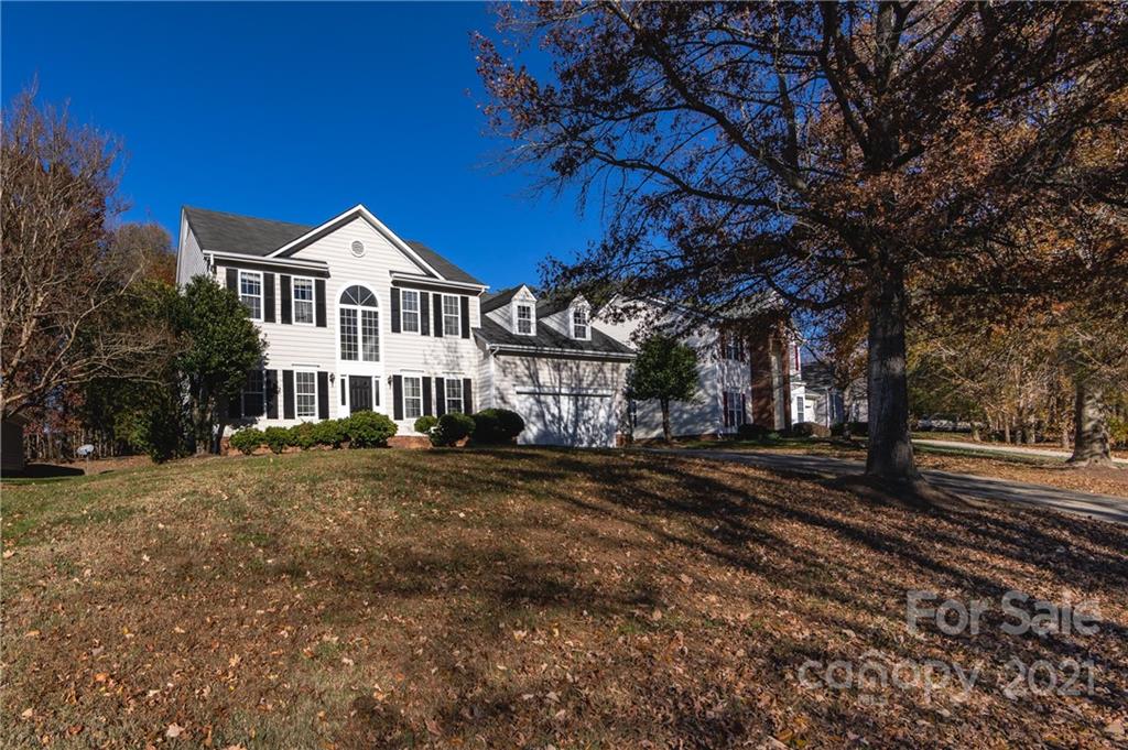 7424 Reedy Creek Road Charlotte, NC 28215 - Photo 3 of 48 a front view of a house with a garden