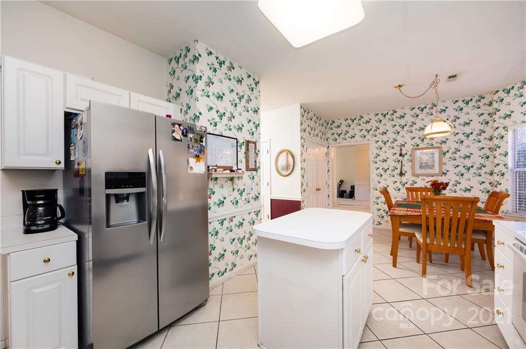 7424 Reedy Creek Road Charlotte, NC 28215 - Photo 22 of 48 a kitchen with stainless steel appliances a refrigerator and a dining table