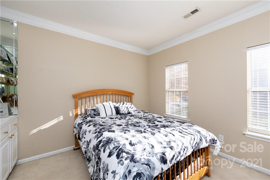 7424 Reedy Creek Road Charlotte, NC 28215 - Photo 8 of 48 a bedroom with a bed and a window