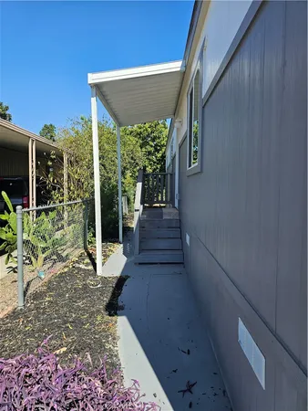 a view of a house with backyard and porch