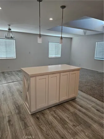 a kitchen with a sink cabinets and wooden floor