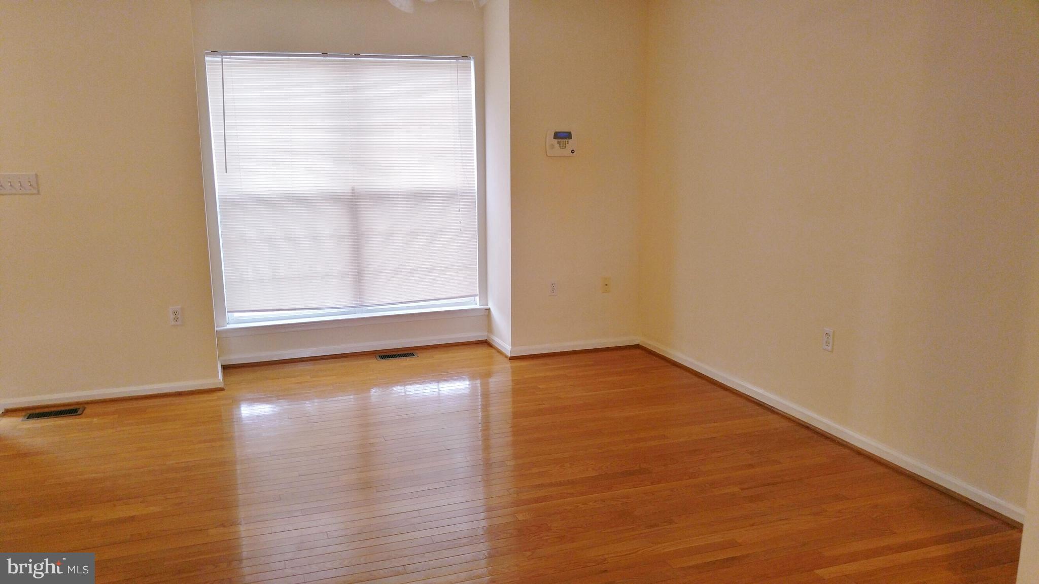 102 Chatham Square Winchester, VA 22601 - Photo 2 of 29 an empty room with wooden floor and windows