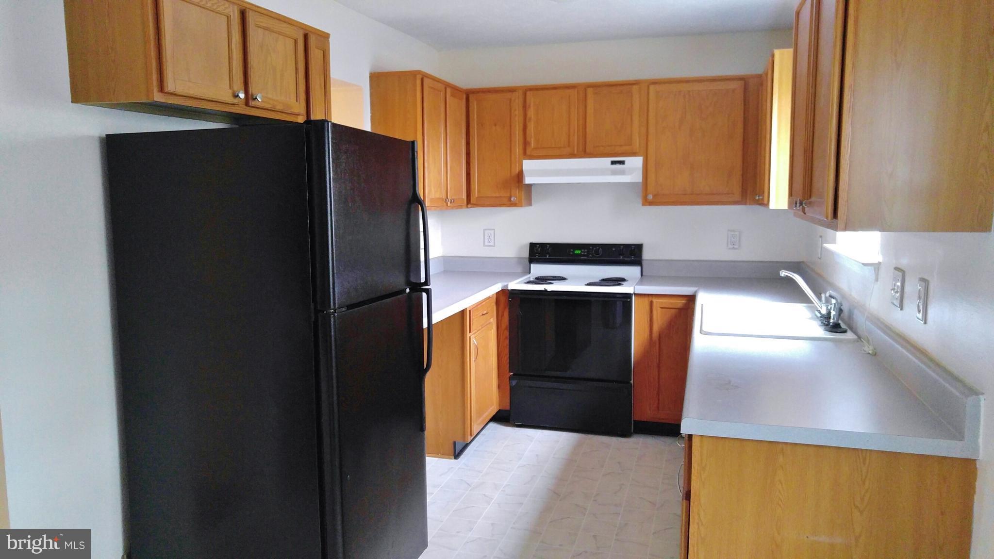 102 Chatham Square Winchester, VA 22601 - Photo 3 of 29 a kitchen with stainless steel appliances granite countertop a refrigerator a stove and a sink