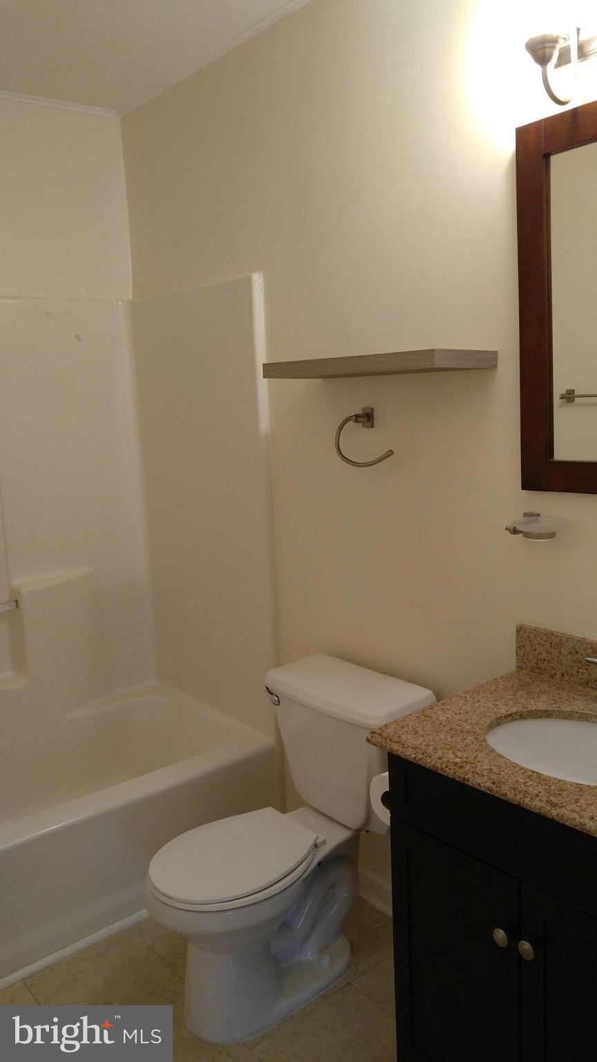 102 Chatham Square Winchester, VA 22601 - Photo 22 of 29 a bathroom with a granite countertop toilet sink and mirror
