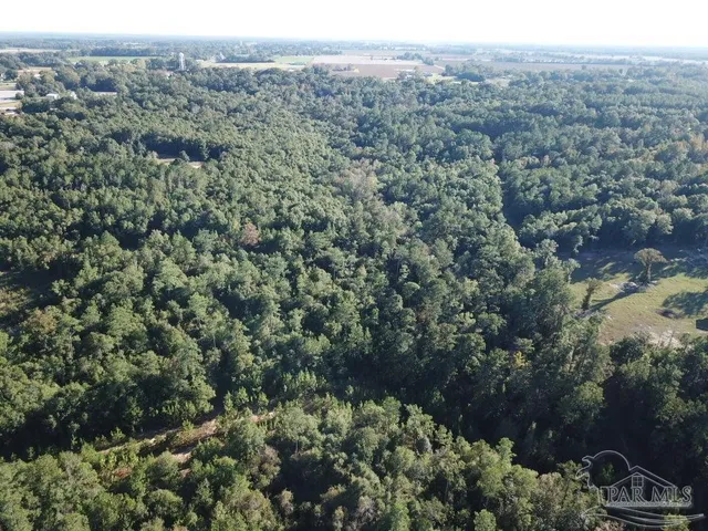 an aerial view of a houses with a yard