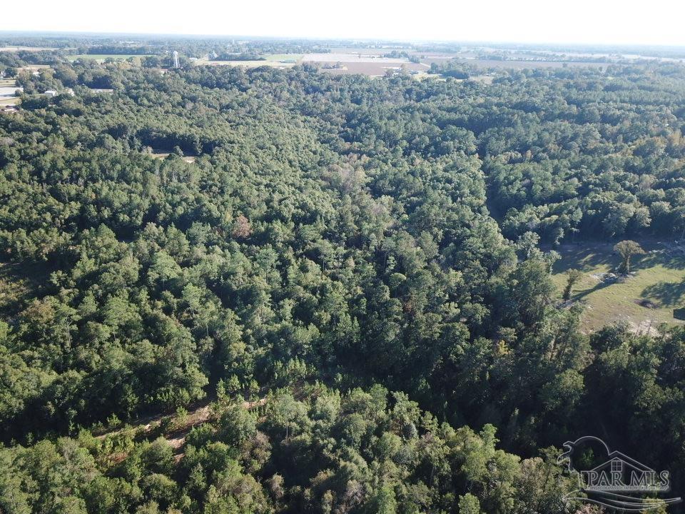 an aerial view of a houses with a yard