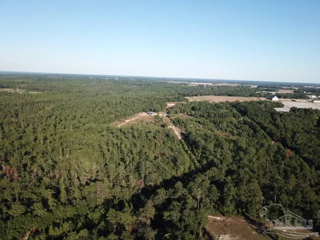 an aerial view of a houses with a yard