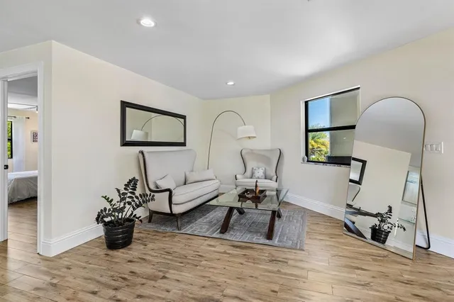 a bedroom with a large bed a couch and a window