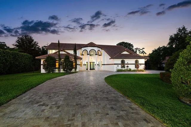 an aerial view of a house with yard and green space