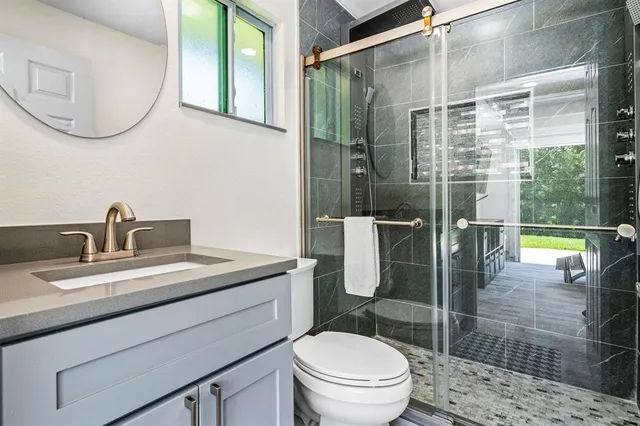 a view of an swimming pool with a yard in front of house