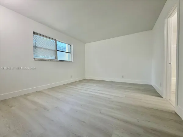 an empty room with a empty space and window
