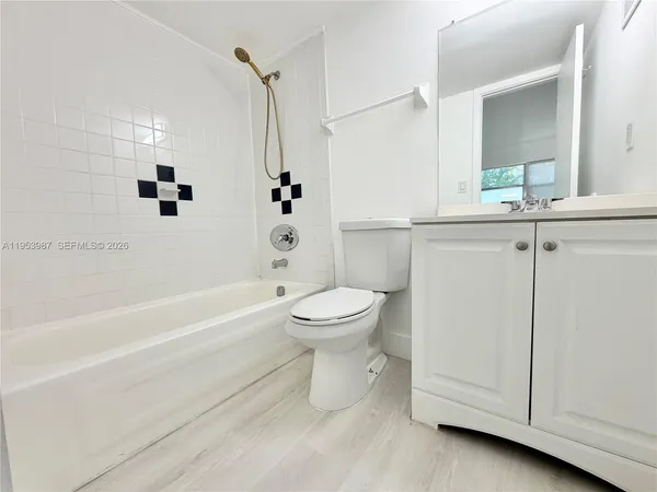a bathroom with a toilet sink and shower