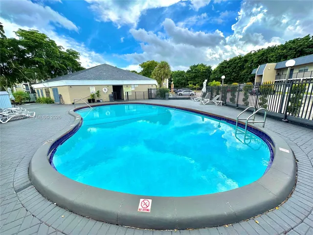 a view of a yard with swimming pool