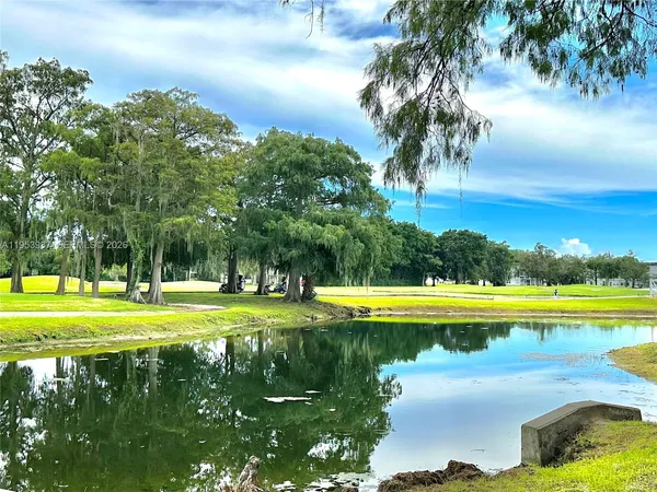 a view of a swimming pool with an outdoor space and seating area