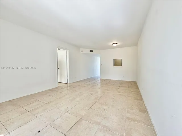 an empty room with white walls